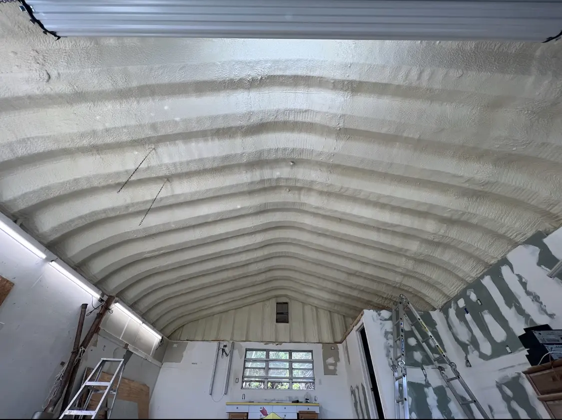 Spray polyurethane foam applied to the underside of a metal roof deck in New Albany